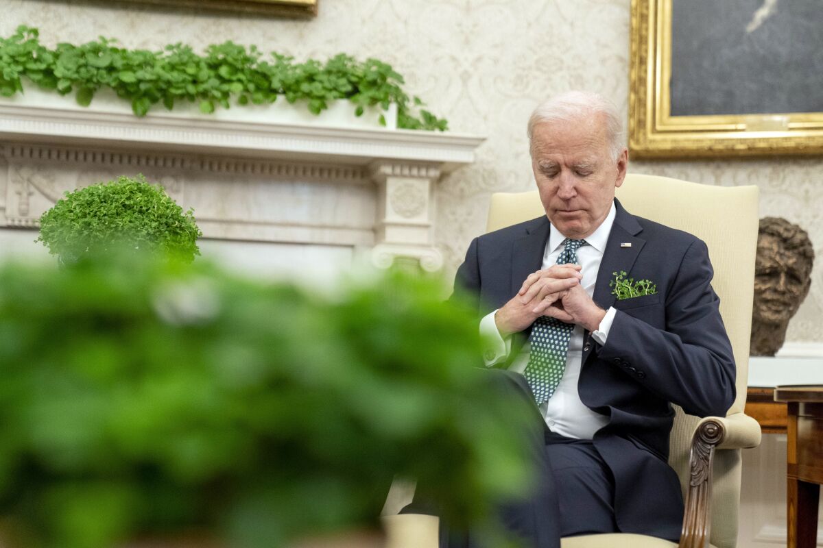 President Biden sits in the Oval Office.