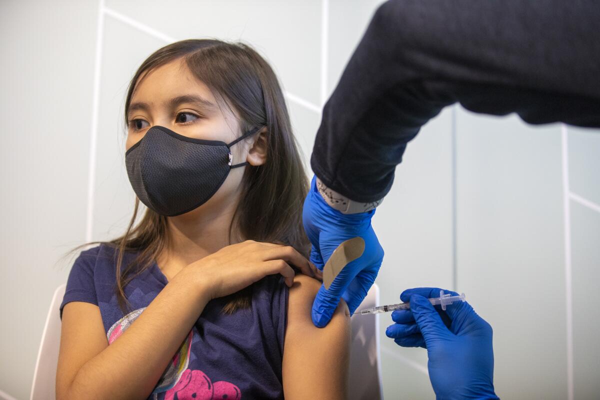 Kailyn Nguyen, 9, gets a COVID-19 vaccination at Kaiser Permanente Tustin Ranch on Nov. 4.