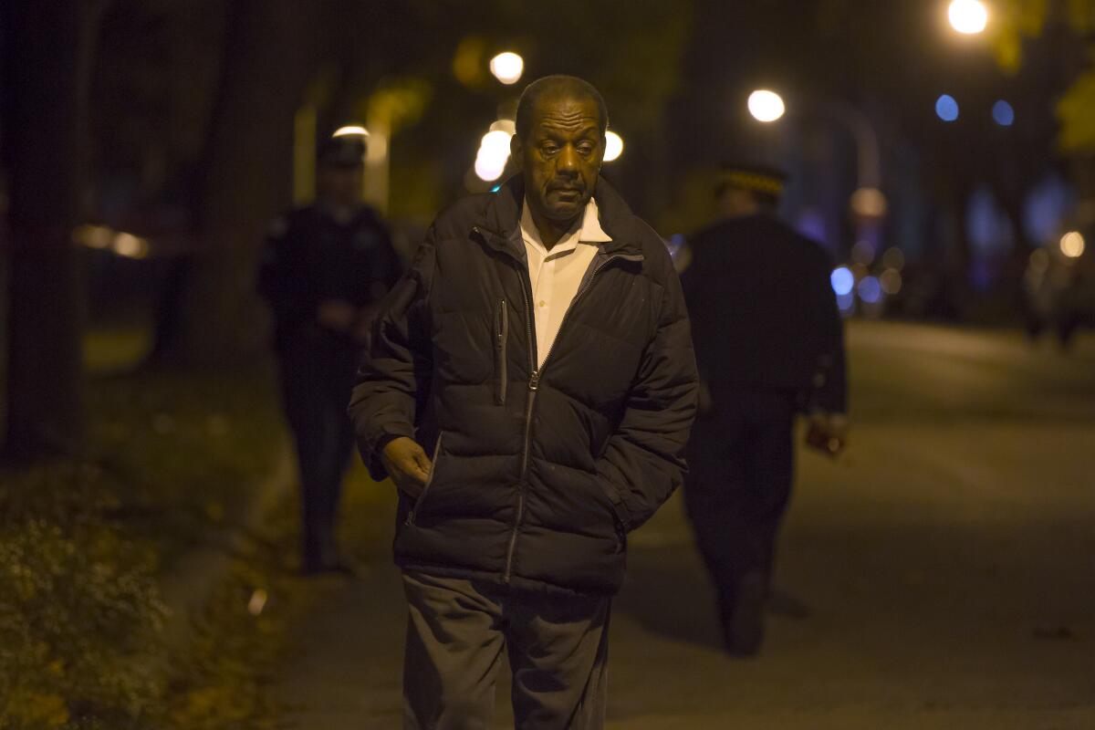 Charles Raymond, 74, of the Hyde Park neighborhood, walks away from the scene in the 5600 block of South Princeton Avenue where the 15-year-old grandson of U.S. Rep. Danny Davis was killed Nov. 18, 2016, in the Englewood neighborhood. Raymond, a family friend, drove the teen's grandmother to the scene.
