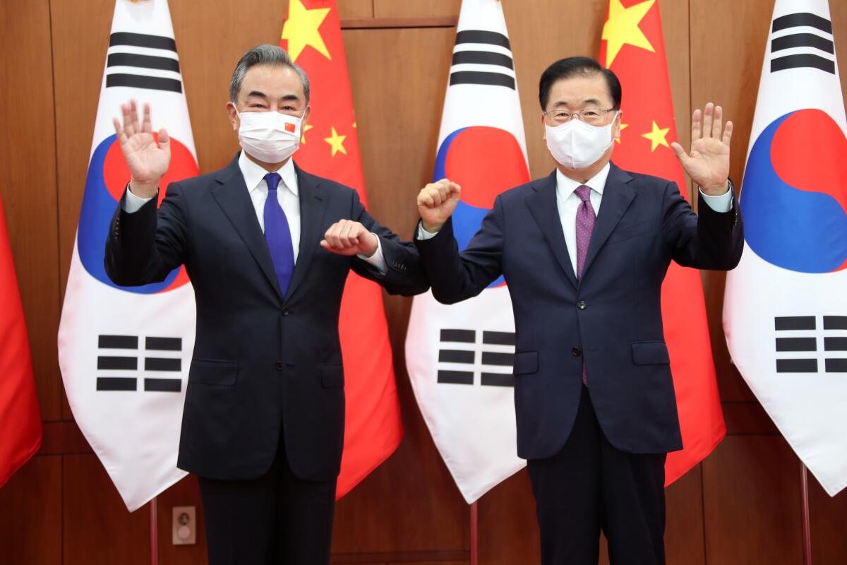 Chinese Foreign Minister Wang Yi, left, poses with his South Korean counterpart Chung Eui-yong for a photograph before their meeting at the Foreign Ministry in Seoul, South Korea, Wednesday, Sept. 15, 2021. The foreign ministers met Wednesday for talks expected to focus on North Korea and other regional security issues, two days after North Korea claimed to have tested a newly developed cruise missile. (Kim Seung-doo/Yonhap via AP)