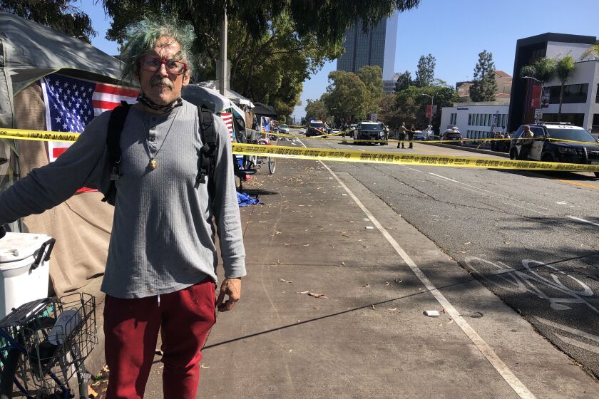 GemBob Brookhyser stands at a San Vincente Boulevard homeless encampment