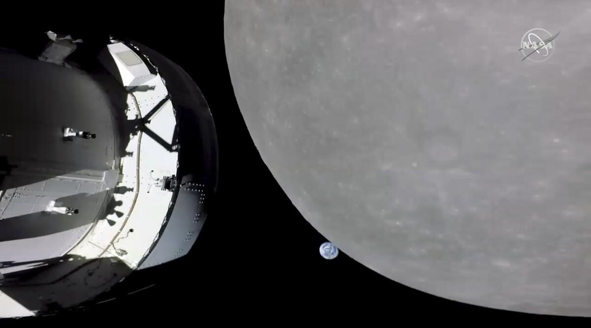 The Orion capsule approaches the moon.