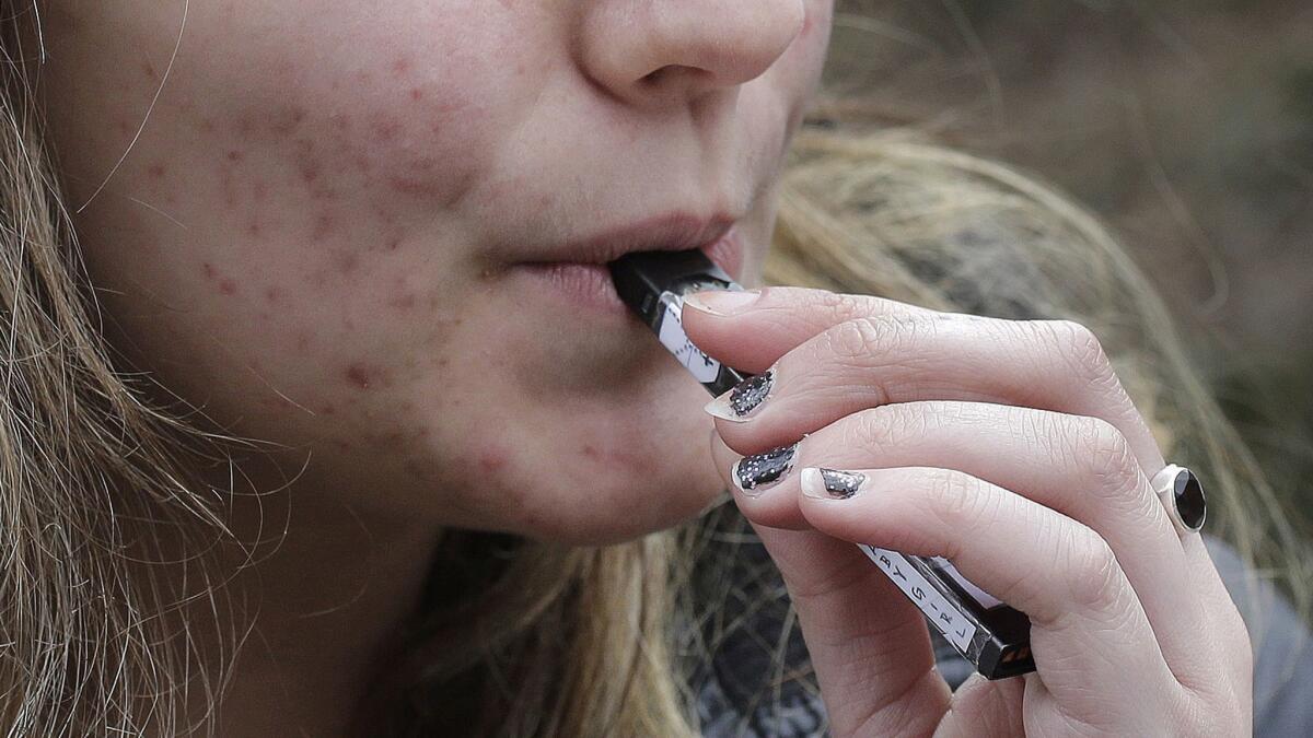 U.S. health regulators are moving ahead with a plan to keep e-cigarettes out of the hands of teenagers by restricting sales of most flavored products in convenience stores and online.