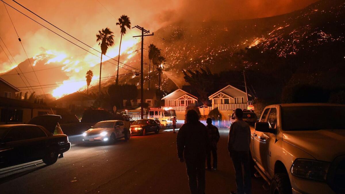 Residents watch last year's Thomas fire, the kind of conflagration that will worsen and become more common with climate change.