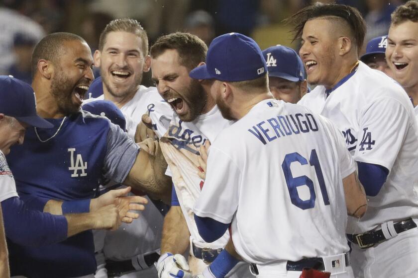 LOS ANGELES, CA, TUESDAY, SEPTEMBER 18, 2018 - Teammates mob Dodgers second baseman Chris Taylor after he hit a walk-off homer in the 10th inning to beat the Rockies 3-2 at Dodger Stadium. (Robert Gauthier/Los Angeles Times)