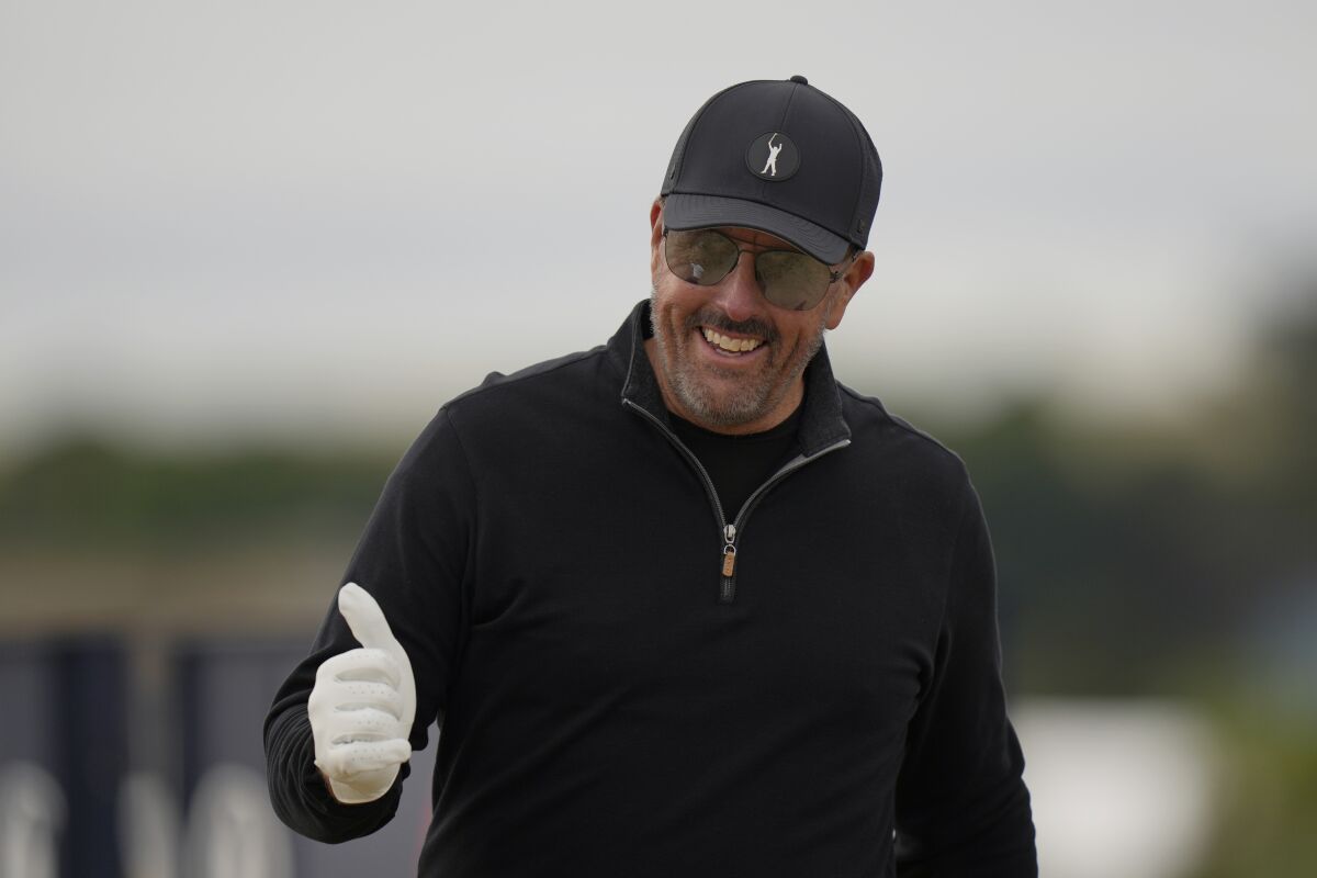 Phil Mickelson of the US gestures as he leaved the 3rd tee during the first round of the British Open golf championship on the Old Course at St. Andrews, Scotland, Thursday, July 14 2022. The Open Championship returns to the home of golf on July 14-17, 2022, to celebrate the 150th edition of the sport's oldest championship, which dates to 1860 and was first played at St. Andrews in 1873. (AP Photo/Alastair Grant)