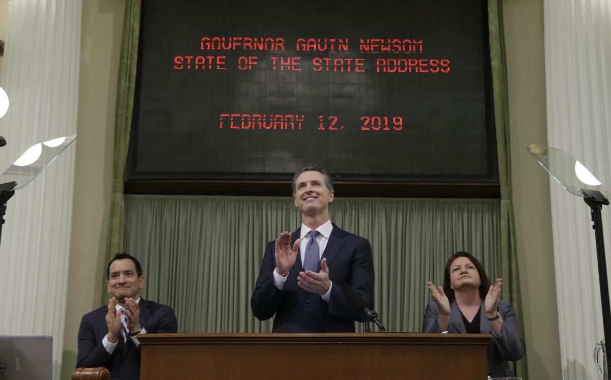 Assembly Speaker Anthony Rendon, left, Gov. Gavin Newsom and Senate President Pro Tem Toni Atkins