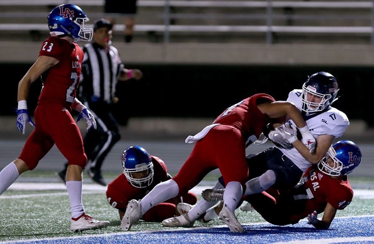 Newport Harbor High School football player #17 Rory McCrory caught a pass in the fourth quarter inside the five-yard line and dragged three players into the end zone for the only score of the night in away game vs. Los Alamitos High School, at Cerritos College in Norwalk on Friday, Oct, 5m 2018. NHHS lost 7-42.