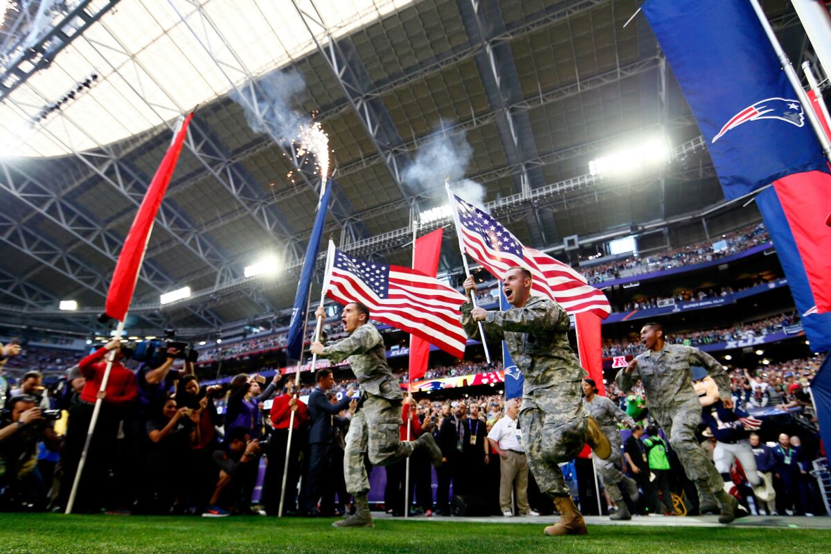 Members of the United States military run onto the field prior to Super Bowl XLIX between the Seattle Seahawks and the New England Patriots.