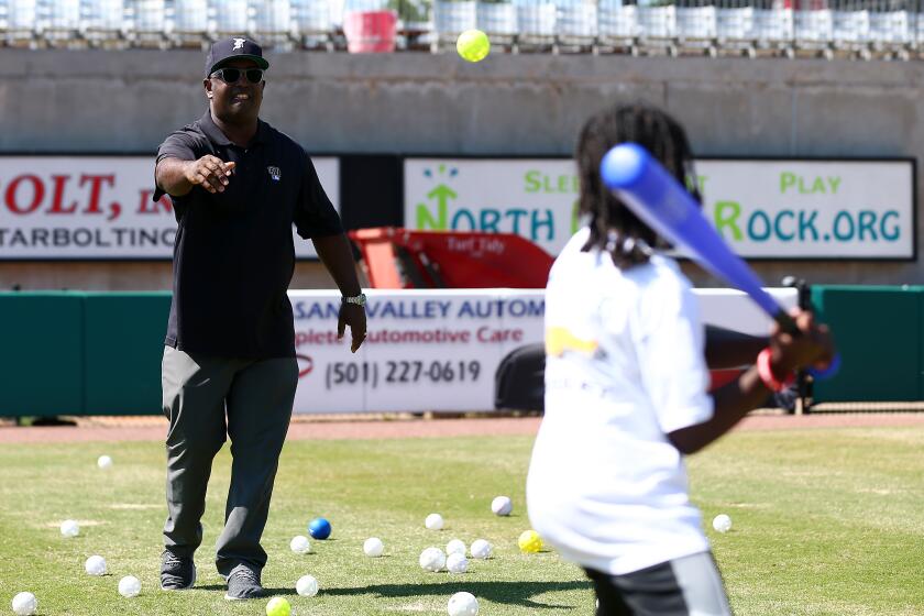 Tony Reagins coaches children during a 2018 MLB event in North Little Rock, Ark.