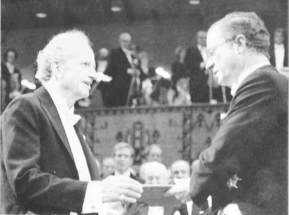 Gary S. Becker, left, receives the 1992 Nobel Prize in economic sciences. Becker is credited with pioneering the approach to economics as a study of human behavior
