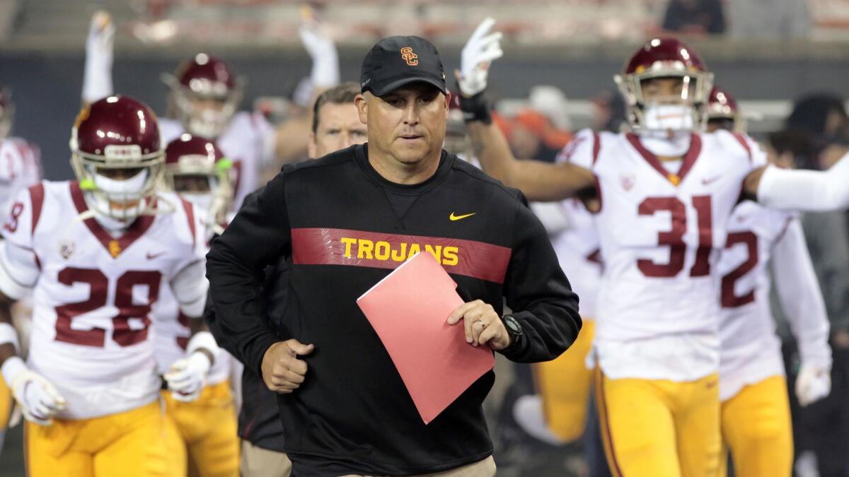 USC coach Clay Helton leads the Trojans onto the field Nov. 3 for a game against Oregon State in Corvallis.