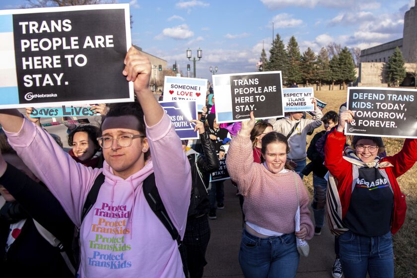 People march around the Nebraska state Capitol during a Transgender Day of Visibility rally, Friday, March 31, 2023, in Lincoln, Neb. (Larry Robinson/Lincoln Journal Star via AP)
