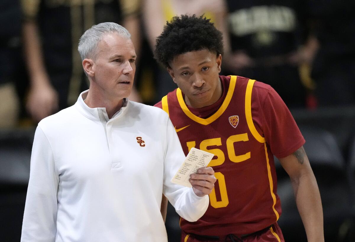 USC coach Andy Enfield, left, talks with guard Boogie Ellis during a game against Colorado on Jan. 20 in Boulder, Colo.