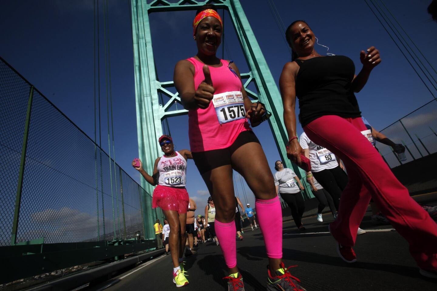Melanie Bunley, left, celebrated her 50th birthday by joining Cherlyn Clark, center, and Yvonne Ali as they and about 3,000 others crossed the Vincent Thomas Bridge twice during the annual 5.3-mile "Conquer the Bridge" race. Proceeds benefit the LAPD Harbor Division Booster Club for Kids.