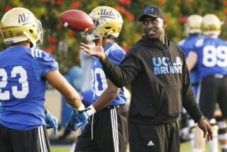 LOS ANGELES, CA - APRIL 6, 2017- UCLA football DeShaun Foster works with running backs.