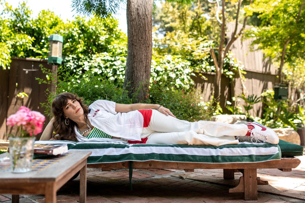 Jenny Lewis reclines outside in a lounge chair