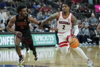 Arizona guard Caleb Love drives against USC guard Bronny James in the Pac-12 tournament.