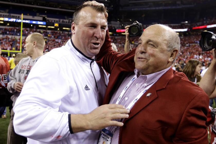 Outgoing Wisconsin Coach Bret Bielema, left, is congratulated by Athletic Director Barry Alvarez after winning the Big Ten Conference championship game over Nebraska.