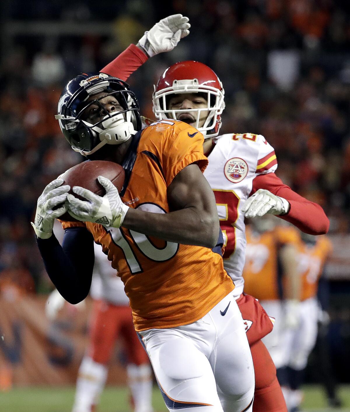 FILE - Denver Broncos wide receiver Emmanuel Sanders (10) pulls in a touchdown pass as Kansas City Chiefs cornerback Phillip Gaines defends during the second half of an NFL football game, Sunday, Nov. 27, 2016, in Denver. Sanders announced his retirement Wednesday, Sept. 7, 2022, after a 12-year NFL career that included six season in Denver, where he helped the Broncos win Super Bowl 50. (AP Photo/Jack Dempsey, File)