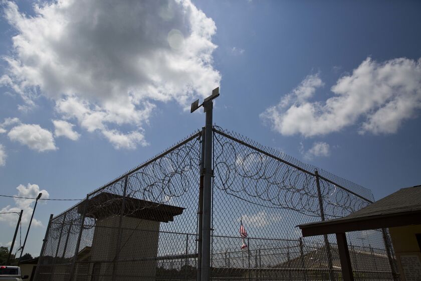 FILE - A fence stands at Elmore Correctional Facility in Elmore, Ala., June 18, 2015. Alabama inmates were in their second day of a work strike Tuesday, Sept. 27, 2022, refusing to labor in prison kitchens, laundries and factories to protest conditions in the state’s overcrowded, understaffed lock-ups. (AP Photo/Brynn Anderson, File)