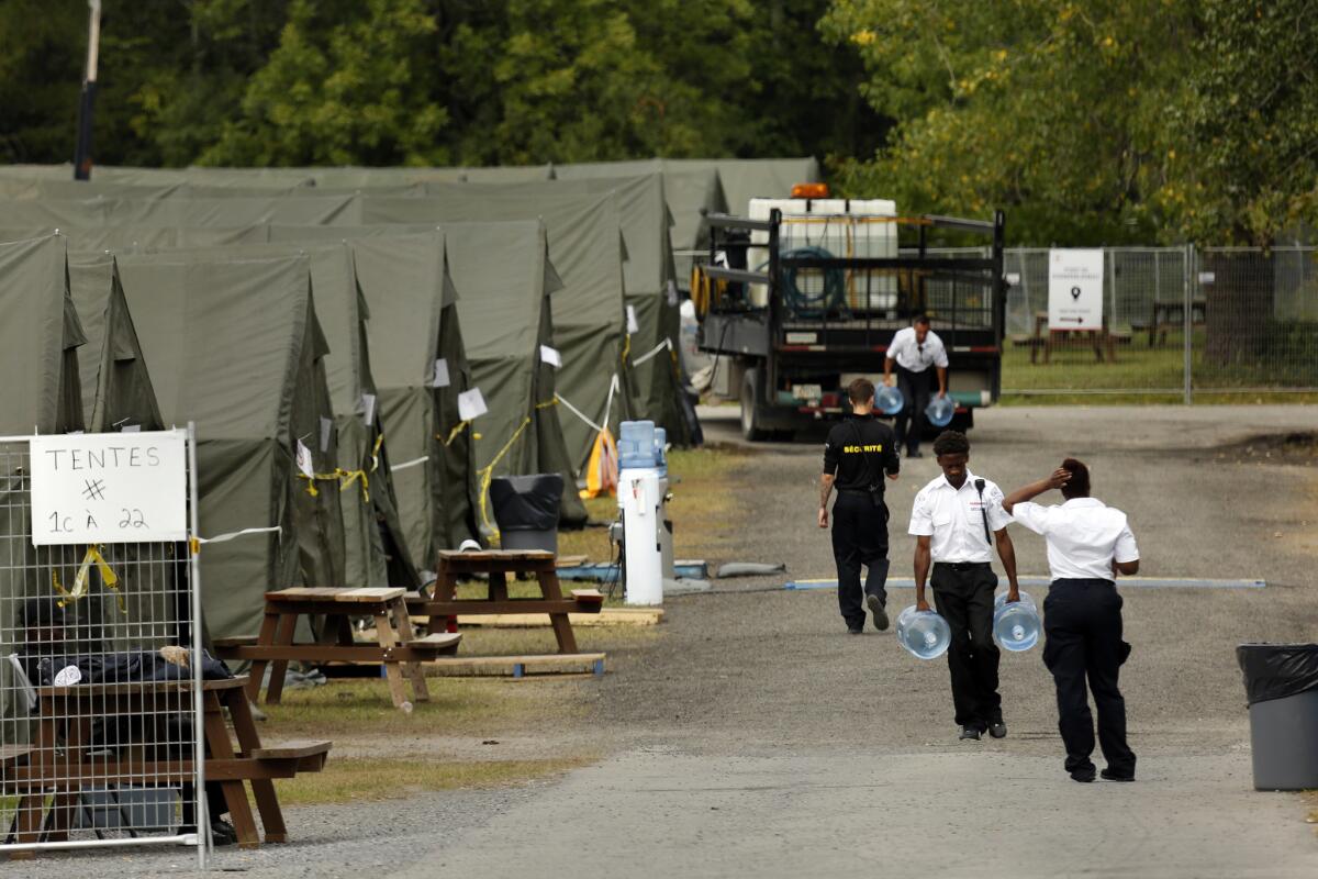 Members of the Canadian armed forces set up a tent village to house migrants while they wait to file asylum applications at the official port of entry in St. Bernard de Lacolle. (Carolyn Cole / Los Angeles Times)