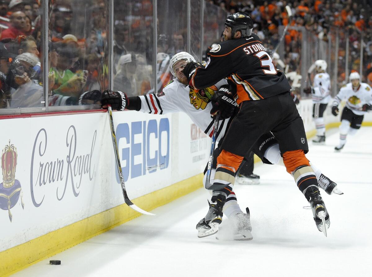 Ducks defenseman Clayton Stoner puts a hit on Blackhawks forward Bryan Bickell during the first period of Game 1.