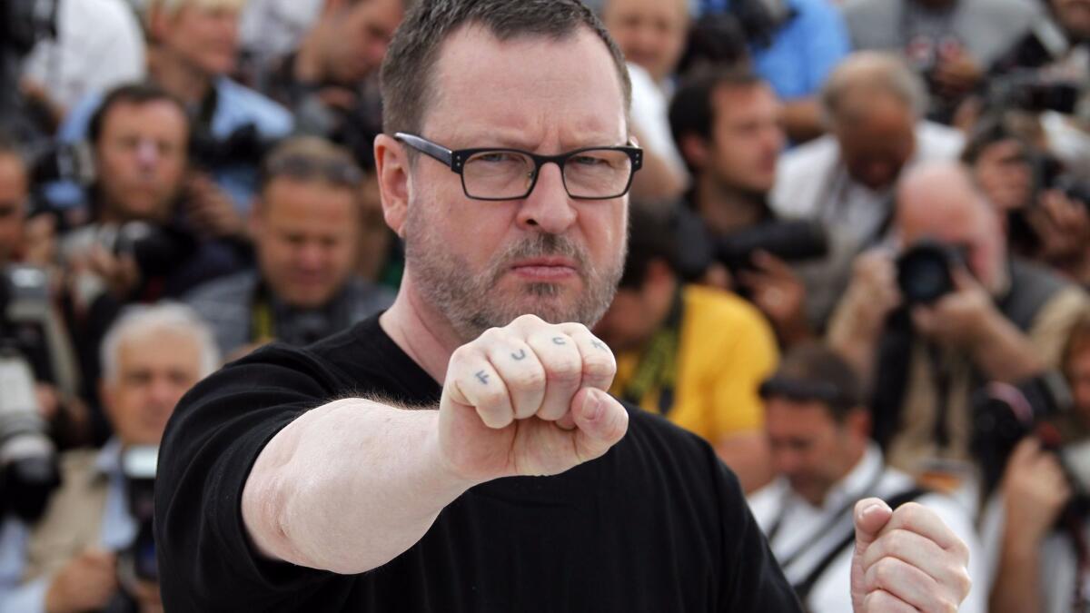 Danish director Lars von Trier at the 64th Cannes Film Festival on May 18, 2011, showing his tattoo while promoting "Melancholia."