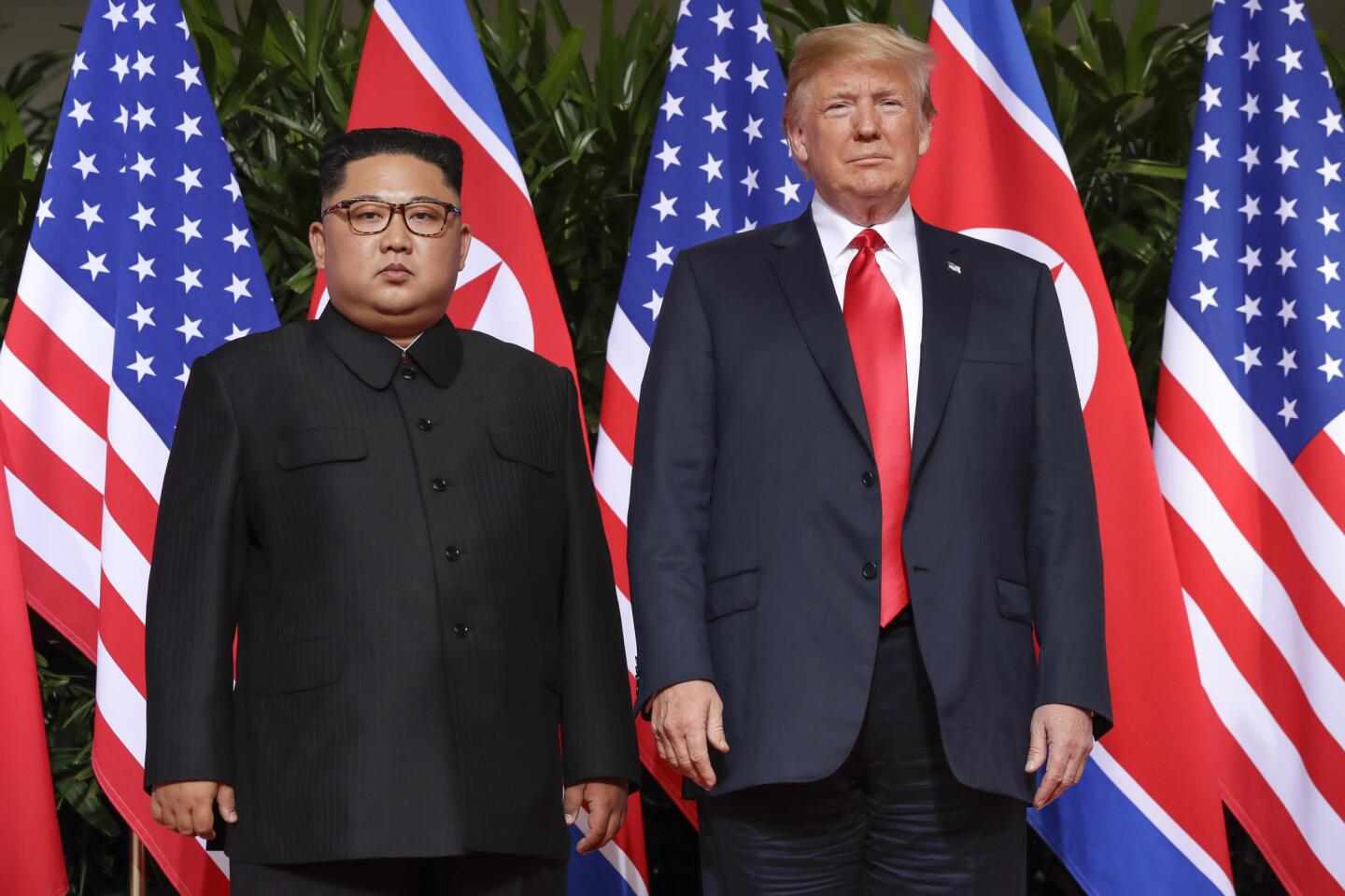 U. S. President Donald Trump stands with North Korea leader Kim Jong Un for a photograph at the Capella resort on Sentosa Island on June 12, 2018, in Singapore.