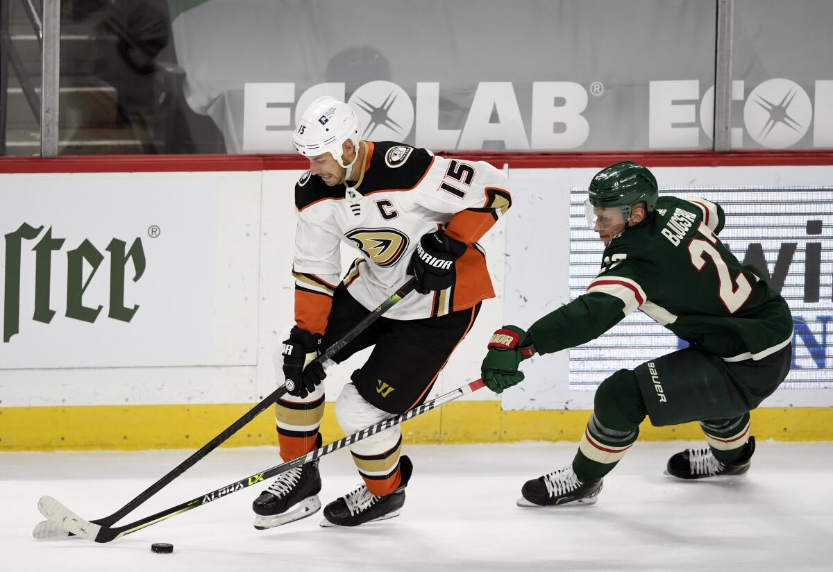 Anaheim Ducks' Ryan Getzlaf is defended by Minnesota Wild's Nick Bjugstad.