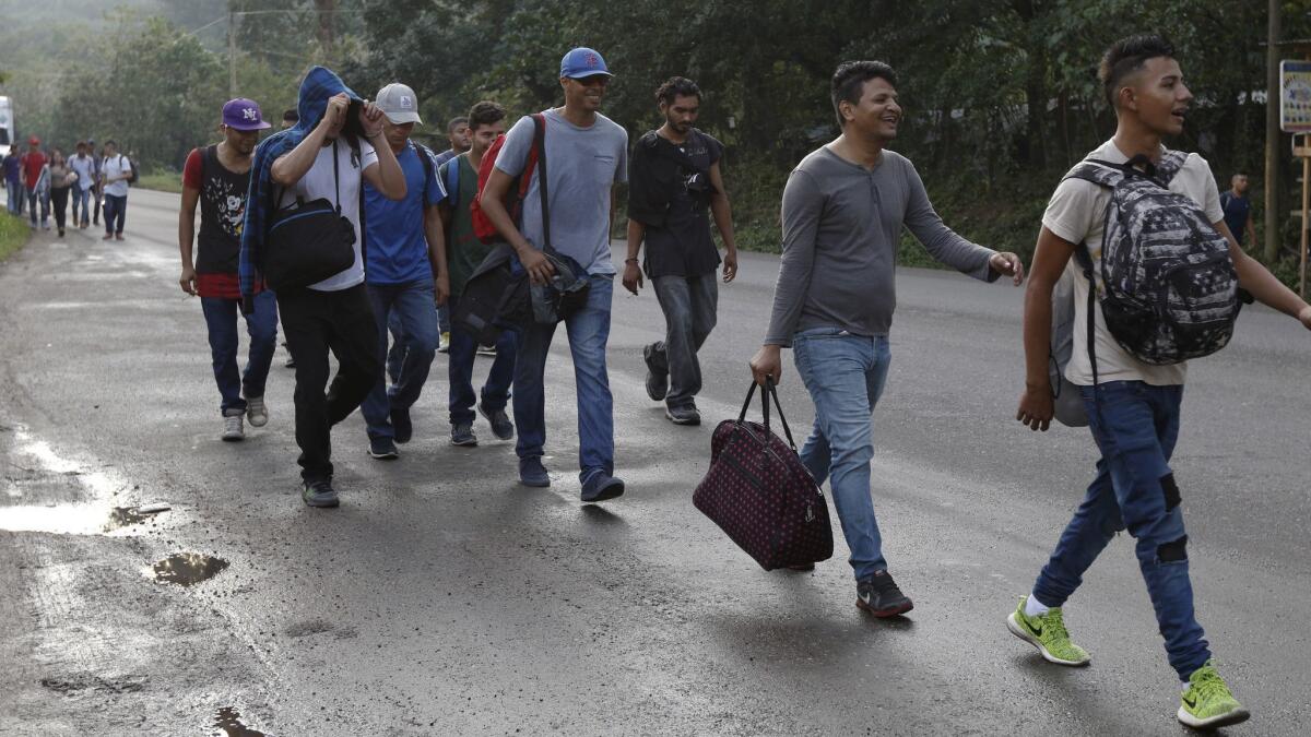 U.S.-bound migrants leave Cofradia, Honduras, early Tuesday along the same route thousands of others have followed on previous caravans.