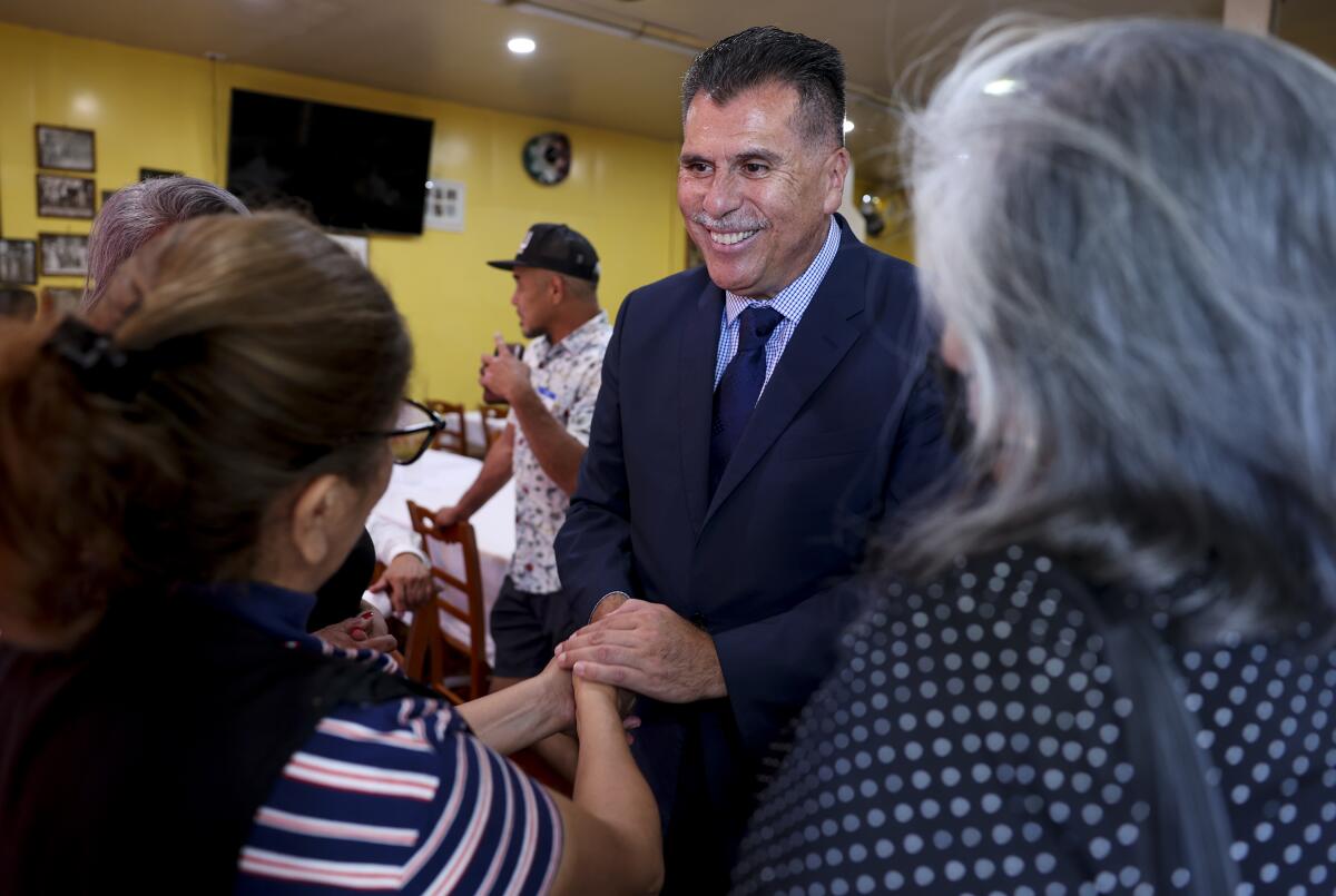 L.A. County sheriff candidate Robert Luna greets people at La Imperial Tortilleria & Restaurant in East Los Angeles.