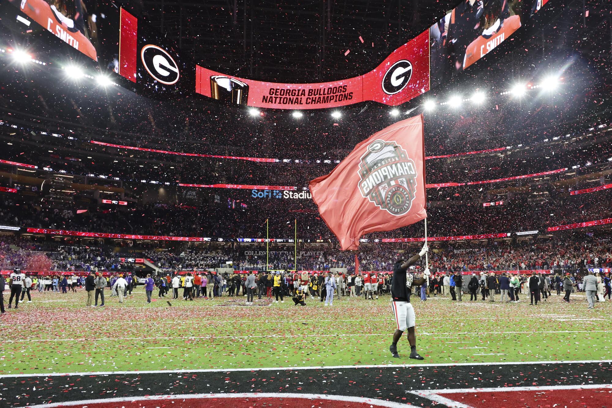 Georgia players and fans celebrate after defeating TCU 65-7 in the college football national championship game.