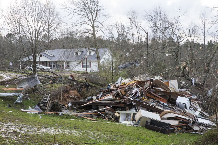 Debris litters weather-damaged properties in Alabama