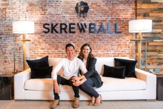 Steven and Brittany Yeng co-founders of Skrewball Whikey sit on a couch.