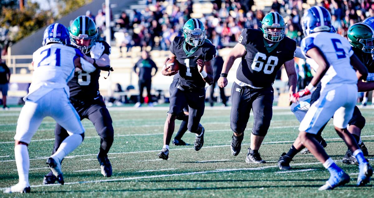 Dijon Stanley of Granada Hills prepares to take off behind the blocking of Phyllip Hamburg-Martinez.