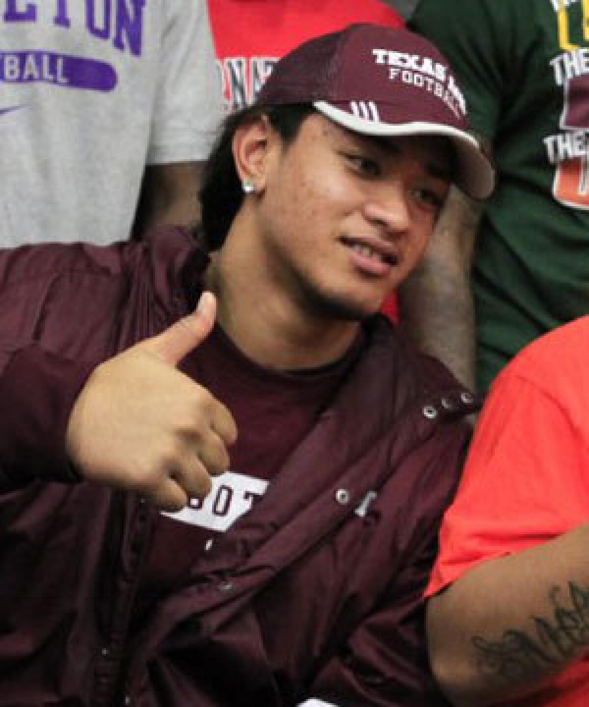 Polo Manukainiu gives a thumbs up after signing a letter of intent to go to Texas A&M in February 2012.