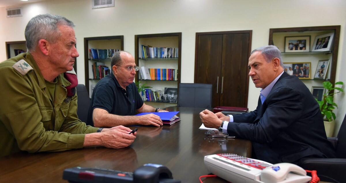 Israeli Prime Minister Benjamin Netanyahu meets July 26 with Defense Minister Moshe Yaalon, center, and Israel Defense Forces Chief of Staff Benny Gantz, left, in the Defense Ministry in Tel Aviv.