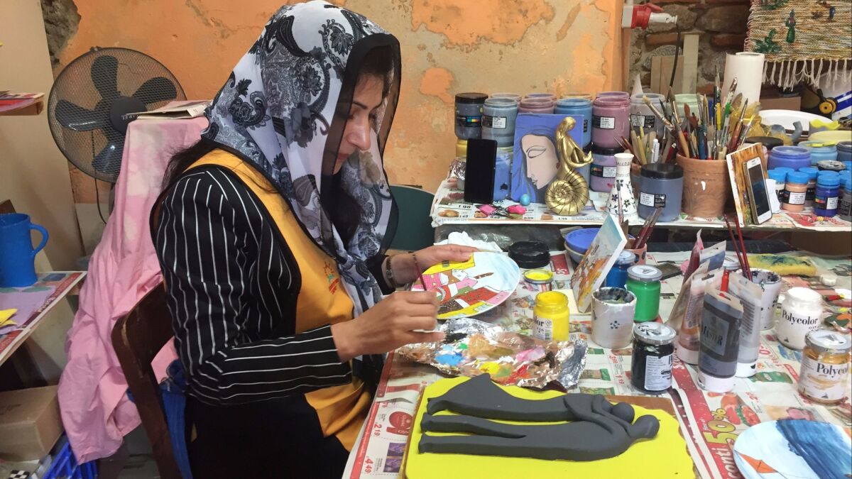 Tahira Yasmine is one of about 500 immigrants living in the small town of Riace in southern Italy. Yasmine, who is from Pakistan, works in a ceramics shop to support her husband and 2-year-old daughter.