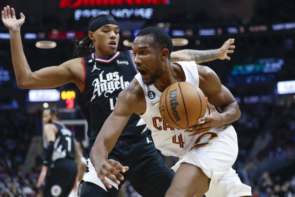 Cleveland Cavaliers forward Evan Mobley, right, drives against Clippers guard Brandon Boston Jr.
