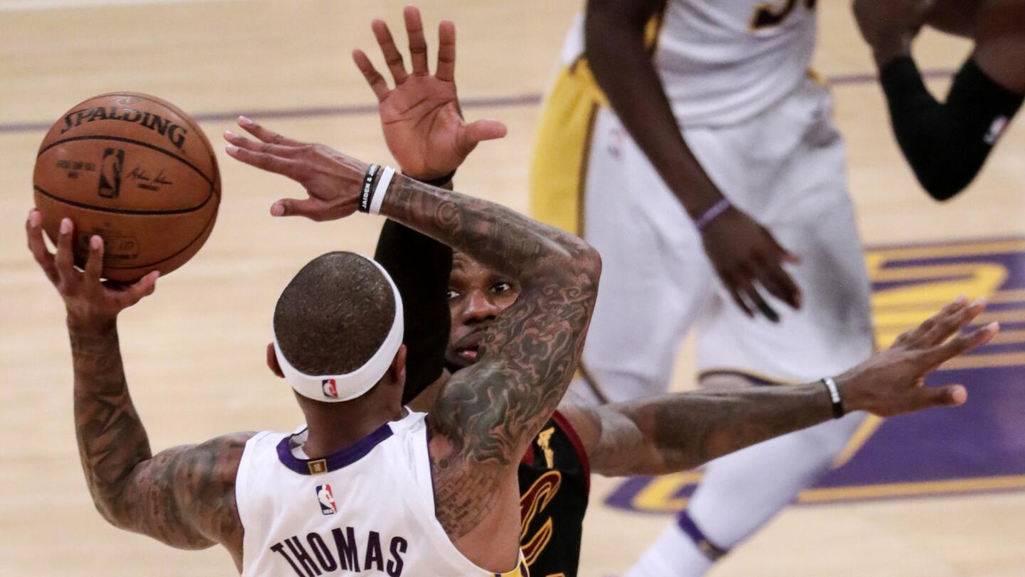Lakers guard Isaiah Thomas shoots over Cavaliers forward LeBron James during fourth quarter action.