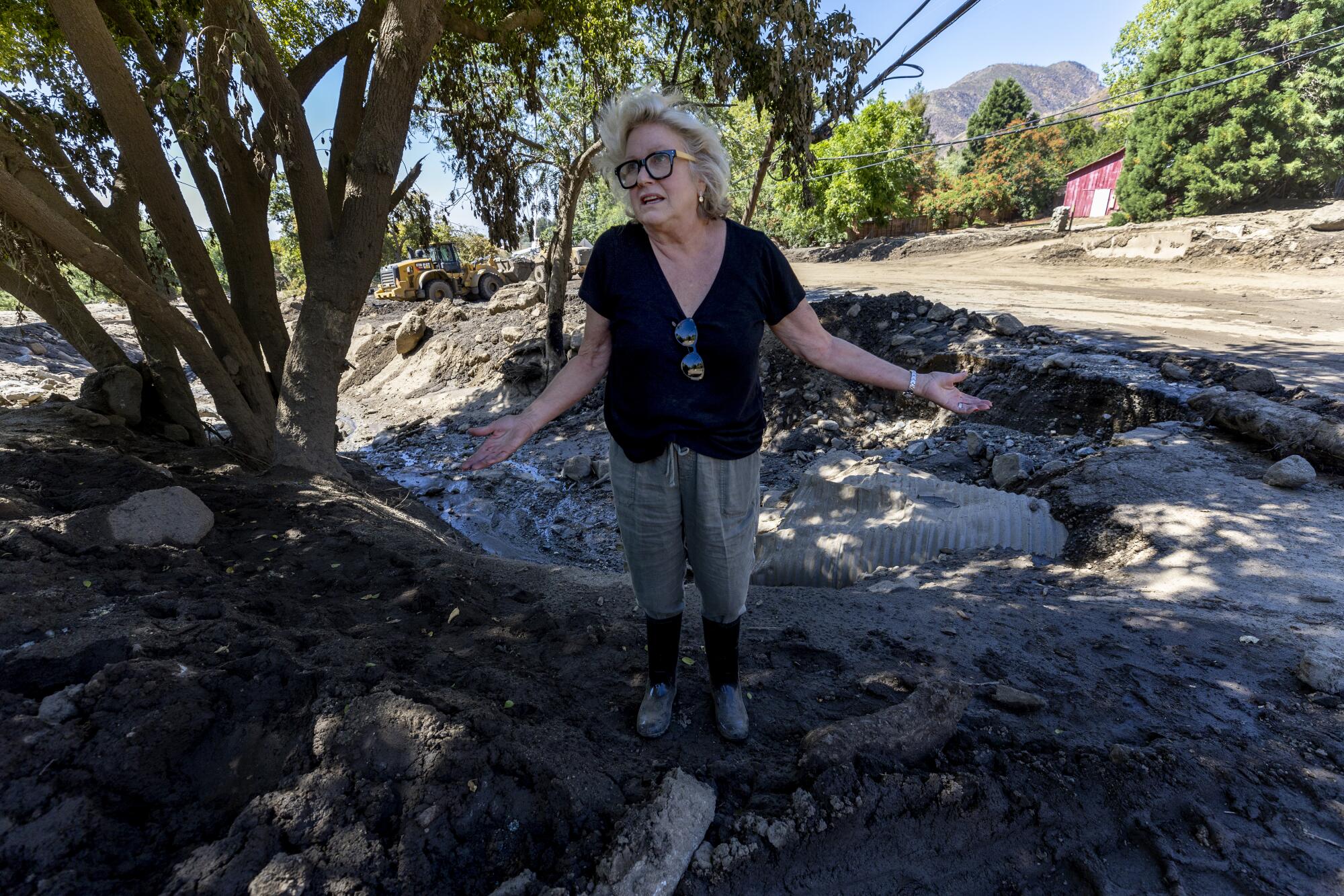 Meg Grant standing near a breached flood channel