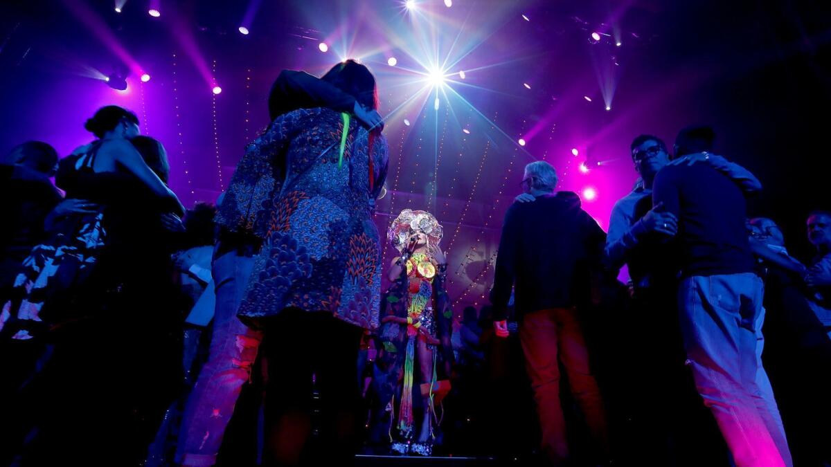 Taylor Mac, center, leads a slow dance, for which audience members were instructed to find a partner who is a stranger of the same sex, in the last chapter of "A 24-Decade History of Popular Music" at the Ace Theatre Saturday.