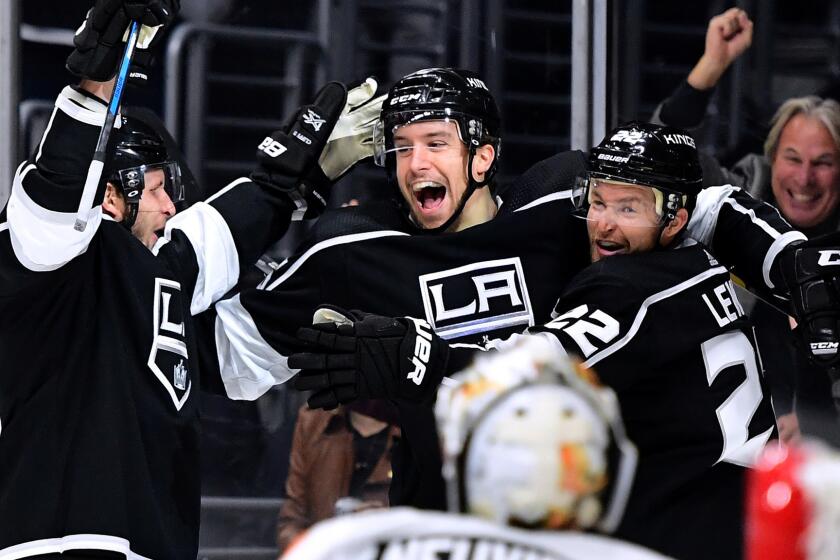 LOS ANGELES, CA - OCTOBER 05: (R-L) Trevor Lewis #22 celebrates his goal with Kurtis MacDermid #56 and Kyle Clifford #13 iin front of Michal Neuvirth #30 of the Philadelphia Flyers to take a 1-0 lead during the second peroid of opening night of the Los Angeles Kings 2017-2018 season at Staples Center on October 5, 2017 in Los Angeles, California. (Photo by Harry How/Getty Images) ** OUTS - ELSENT, FPG, CM - OUTS * NM, PH, VA if sourced by CT, LA or MoD **