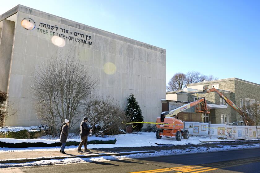 Workers begin demolition Wednesday, Jan. 17, 2023, at the Tree of Life building in Pittsburgh, the site of the deadliest antisemitic attack in U.S. history, as part of the effort to reimagine the building to honor the 11 people who were killed there in 2018. Most the building will be removed, although portions of the sanctuary walls will be preserved. The new building will include spaces for worship and a museum, and will house community activities and an education center. (AP Photo/Gene J. Puskar)