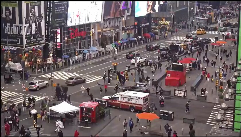 In this image taken from video by the FDNY, pedestrians hurry away from the scene of a shooting in Times Square, Saturday, May 8, 2021, in New York. New York City police say three innocent bystanders including a 4-year-old girl who was toy shopping have been shot in Times Square and officers are looking for suspects. All the victims are expected to recover. (FDNY via AP)