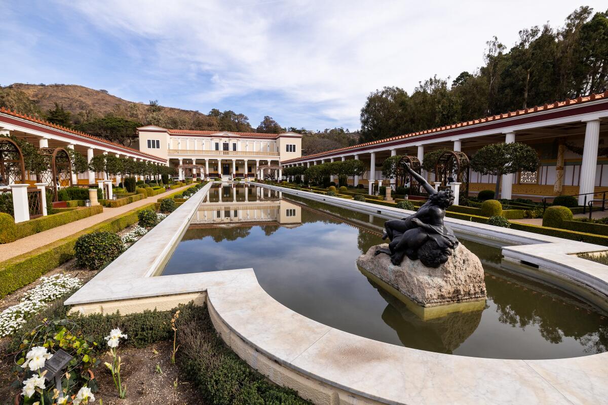 The Getty Villa pool, usually wide is filled with ash from the Palisades fire.