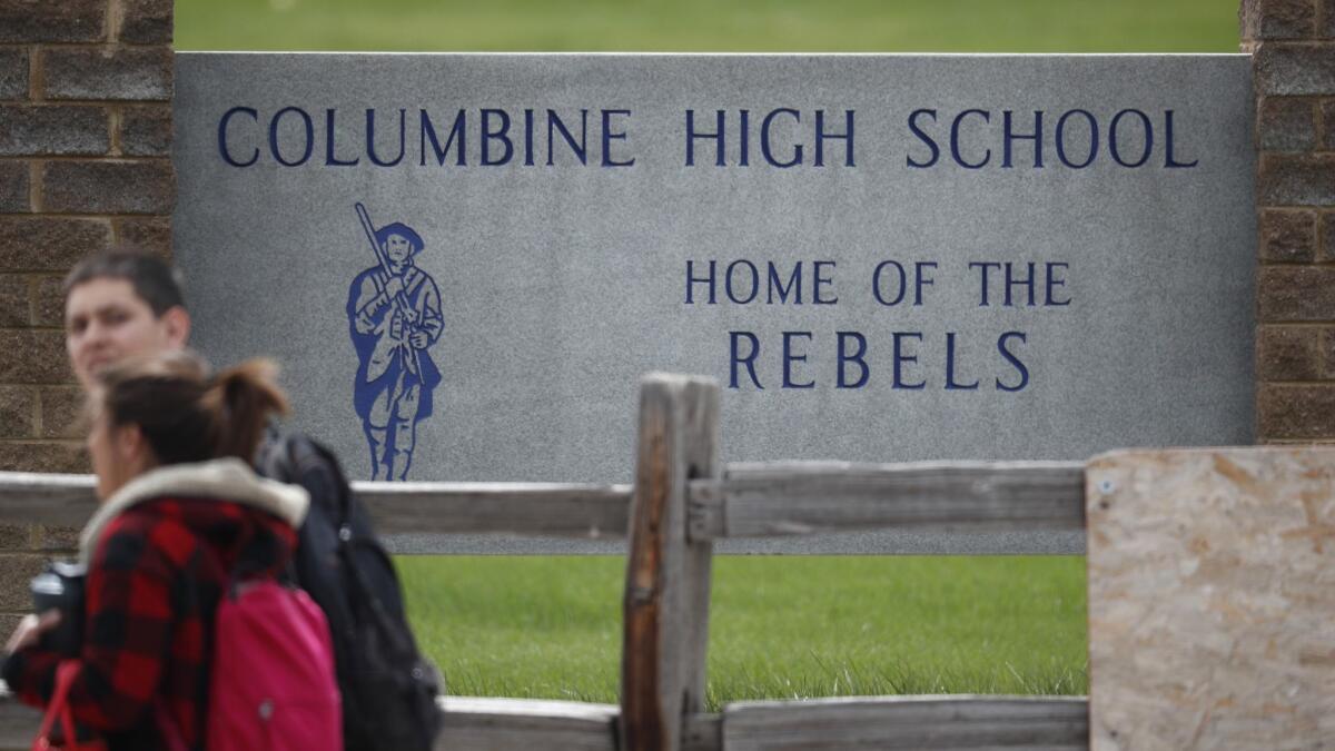 Students leave Columbine High School in Littleton, Colo., late Tuesday after a lockdown there and at other area schools.