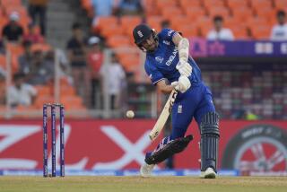 England's Mark Wood bats during the ICC Cricket World Cup opening match between England.