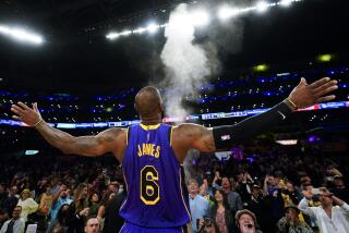 Lakers forward LeBron James (6) throws powdered chalk in the air before an NBA basketball game against the Memphis Grizzlies.